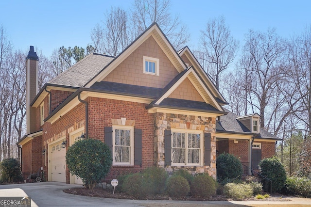 view of front of property featuring concrete driveway, stone siding, a chimney, roof with shingles, and brick siding