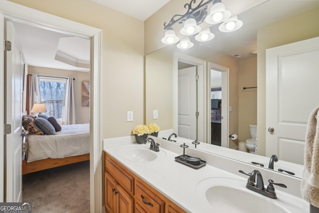 bathroom with a sink, double vanity, toilet, and ensuite bath