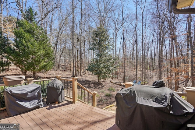 wooden terrace with a grill