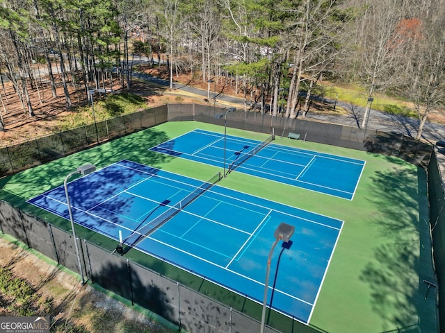 view of sport court featuring fence