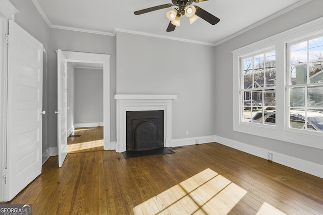 unfurnished living room featuring a fireplace with flush hearth, baseboards, dark wood finished floors, and crown molding