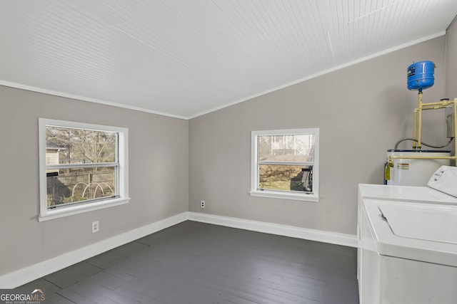 washroom featuring laundry area, plenty of natural light, dark wood-style flooring, and separate washer and dryer