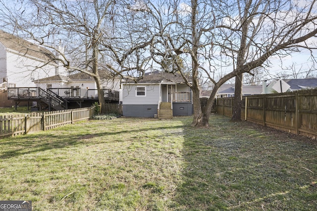 view of yard with a fenced backyard and a wooden deck