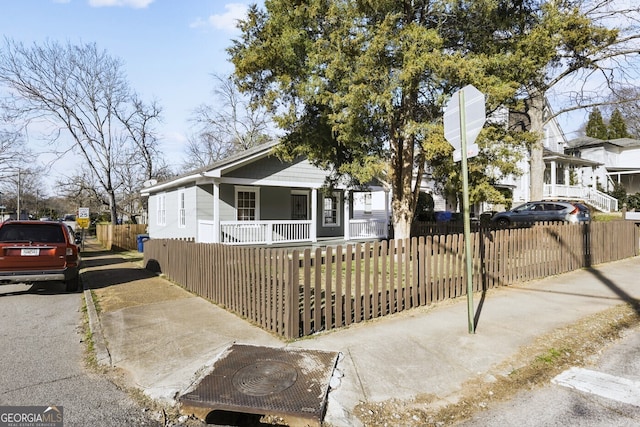 view of front of property featuring a fenced front yard and a porch