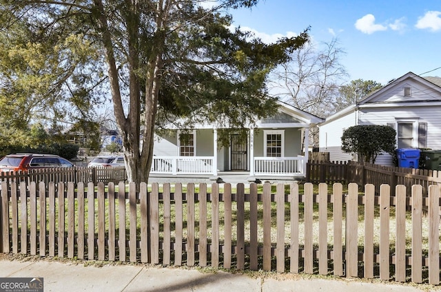 bungalow-style house with a fenced front yard and a porch