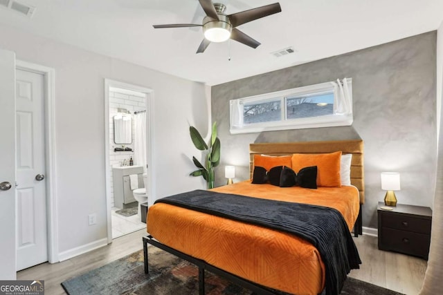 1415 Vesta Ave, Atlanta, GA 30344 - bedroom with wood finished floors, ensuite bath, and a ceiling fan