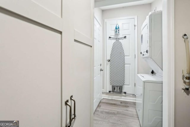 1415 Vesta Ave, Atlanta, GA 30344 - bathroom with stacked washing machine and dryer and wood finished floors