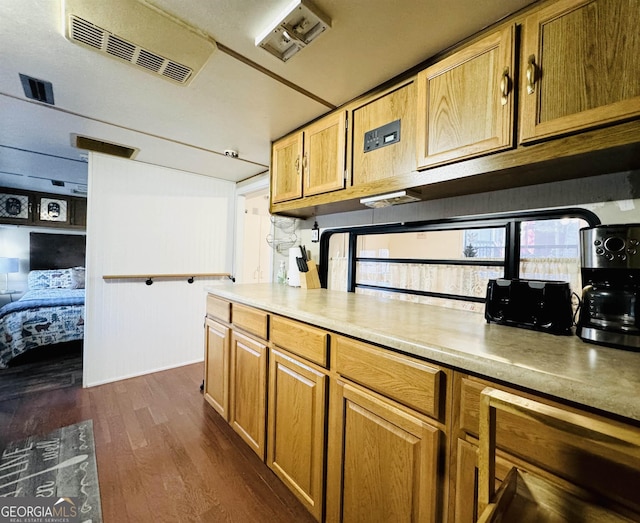 kitchen featuring dark wood-style floors, visible vents, and light countertops