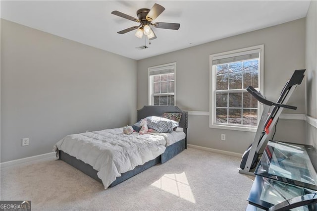 carpeted bedroom featuring ceiling fan and baseboards