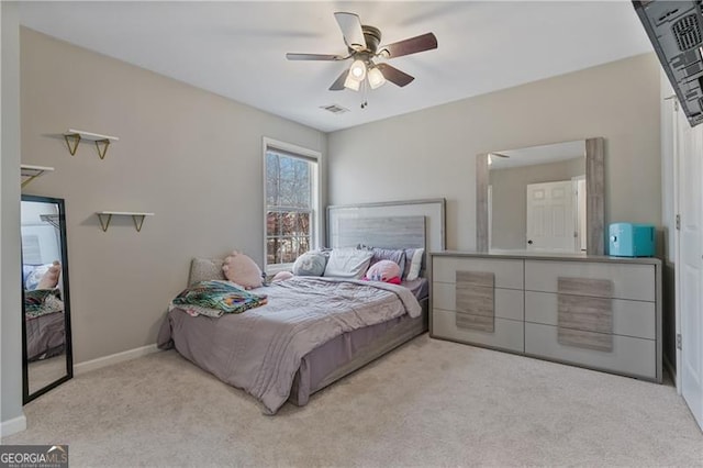 carpeted bedroom with visible vents, ceiling fan, and baseboards