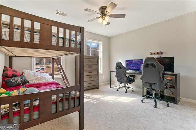 carpeted bedroom featuring visible vents, ceiling fan, and baseboards