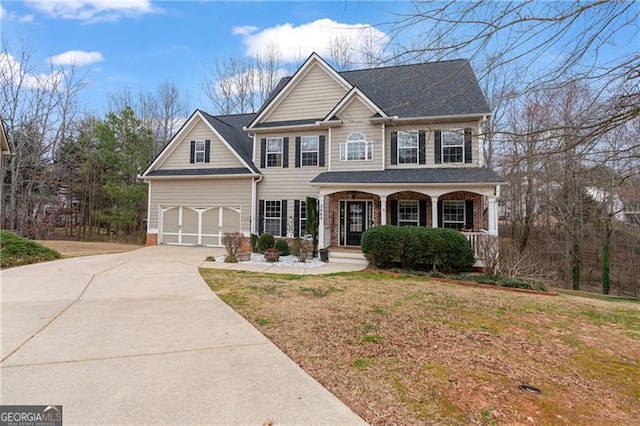 view of front of house featuring driveway, a porch, a front yard, and brick siding