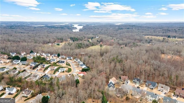 drone / aerial view featuring a wooded view