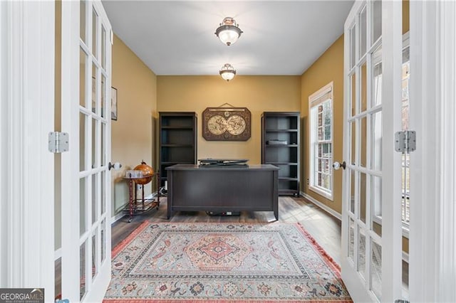 office with french doors and wood finished floors