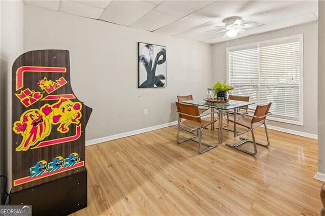 dining room with a ceiling fan, baseboards, and wood finished floors