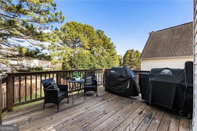 wooden terrace with a grill