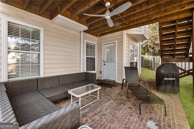 view of patio with ceiling fan, fence, and an outdoor living space