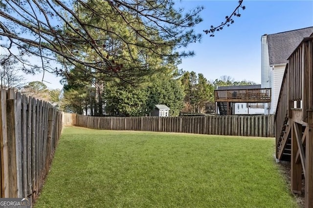 view of yard featuring a deck and a fenced backyard