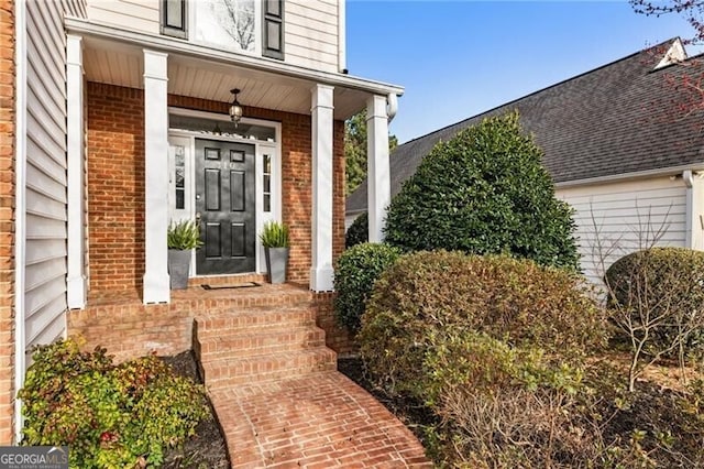 doorway to property featuring brick siding