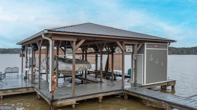 dock area with boat lift and a water view