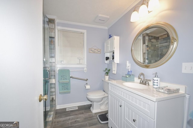 full bathroom with wood finish floors, toilet, a shower stall, and crown molding