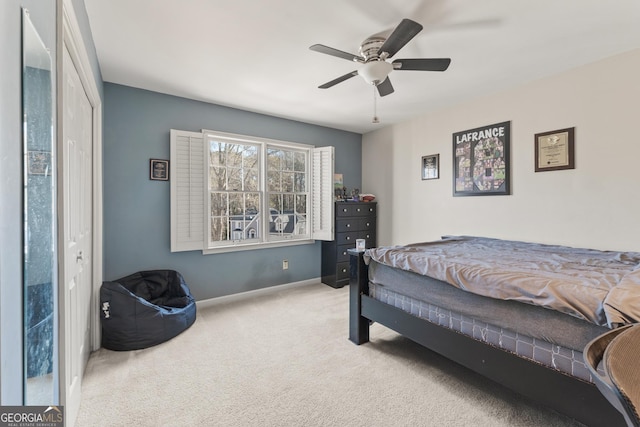 bedroom featuring baseboards, carpet floors, and a ceiling fan