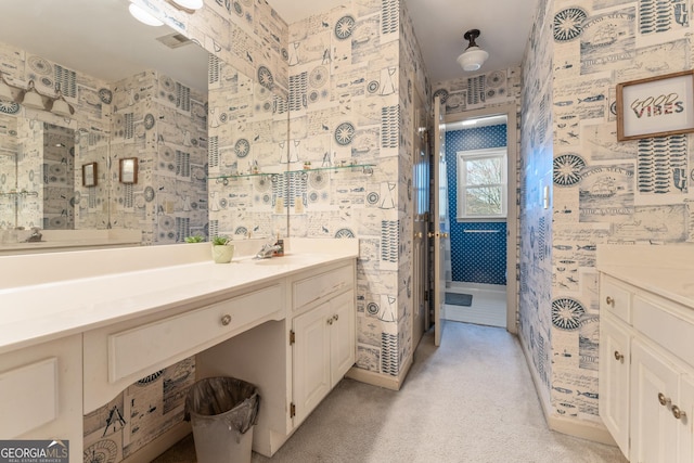 full bath featuring wallpapered walls, vanity, and visible vents