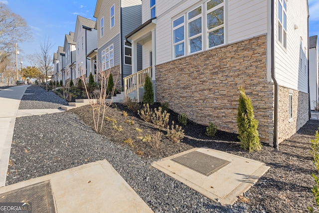 exterior space with a residential view and stone siding