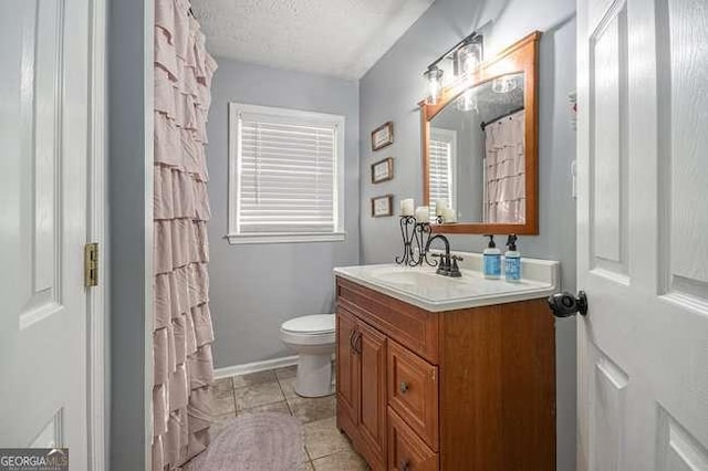 full bath featuring vanity, a shower with shower curtain, tile patterned flooring, a textured ceiling, and toilet