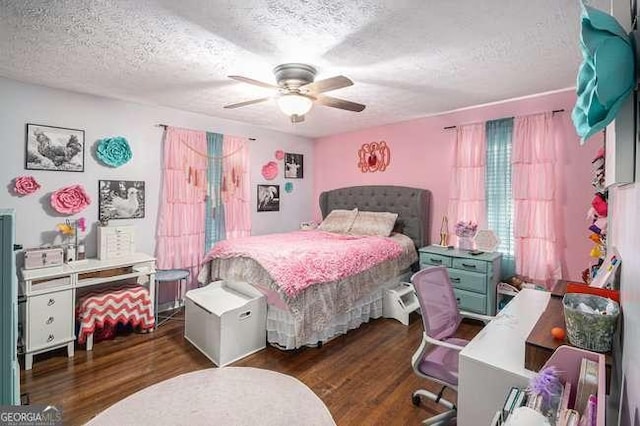 bedroom featuring ceiling fan, wood finished floors, and a textured ceiling