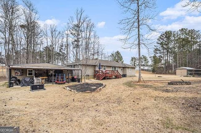 back of house with an outbuilding and an outdoor structure