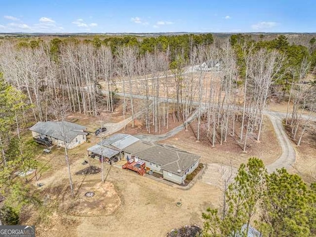 bird's eye view featuring a wooded view