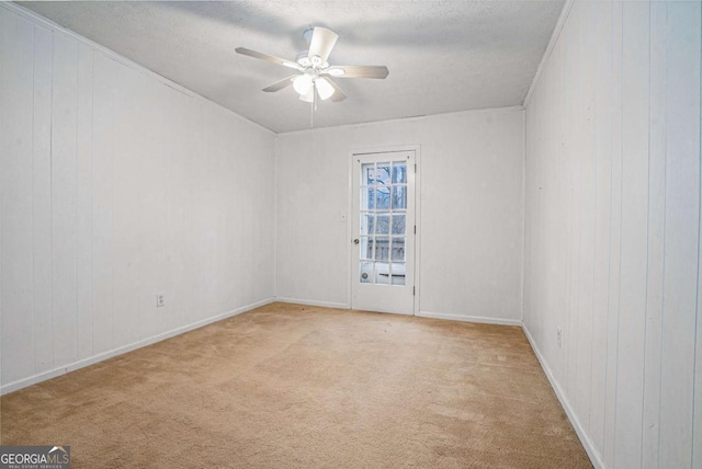 unfurnished room featuring light carpet, a textured ceiling, and a ceiling fan