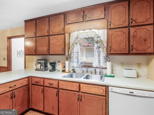 2643 Rocky Creek Rd, Hampton, GA 30228 - kitchen featuring light countertops, brown cabinets, white dishwasher, and a sink