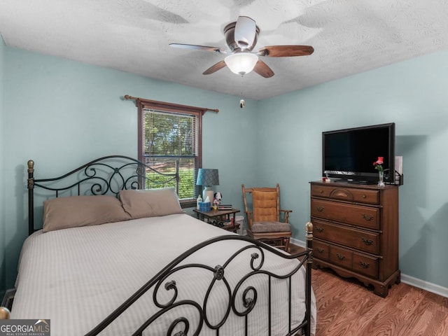 2643 Rocky Creek Rd, Hampton, GA 30228 - bedroom featuring a ceiling fan, wood finished floors, baseboards, and a textured ceiling