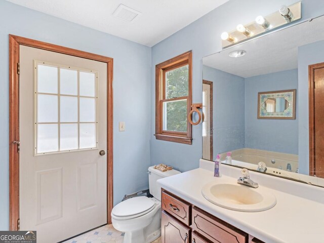 2643 Rocky Creek Rd, Hampton, GA 30228 - bathroom featuring visible vents, a garden tub, vanity, and toilet
