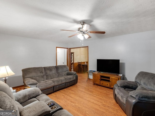 2643 Rocky Creek Rd, Hampton, GA 30228 - living area with light wood finished floors, a textured ceiling, and a ceiling fan
