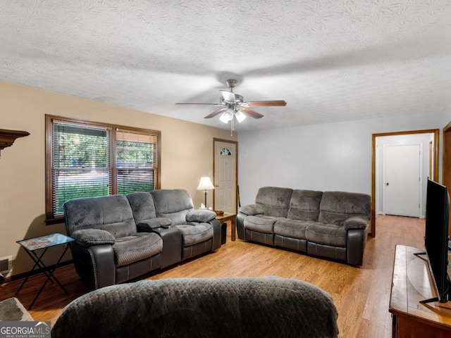 2643 Rocky Creek Rd, Hampton, GA 30228 - living area with a textured ceiling, visible vents, light wood finished floors, and ceiling fan