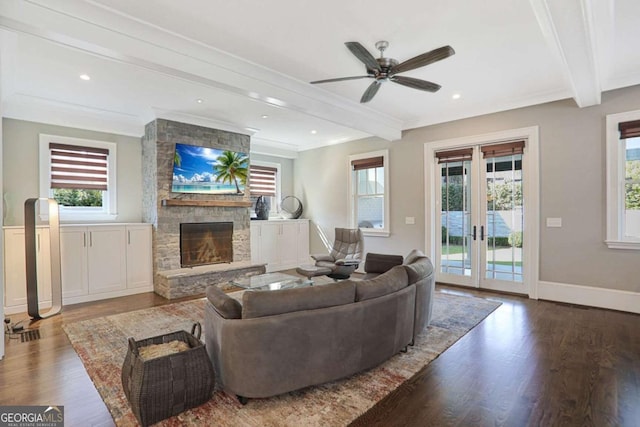 living area featuring wood finished floors, baseboards, beam ceiling, a fireplace, and french doors