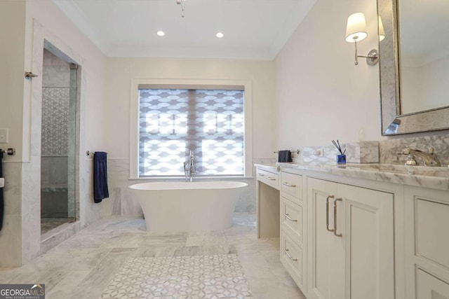 full bathroom featuring vanity, crown molding, a freestanding tub, and a stall shower