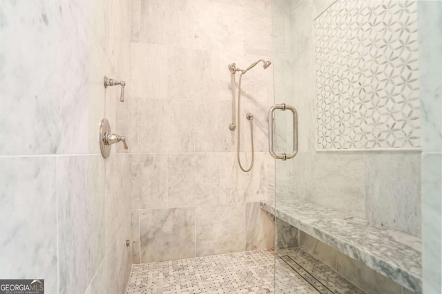 full bath with a tile shower