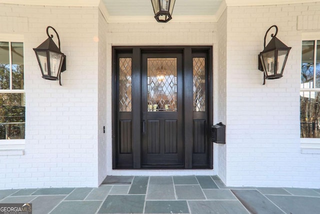 doorway to property with brick siding