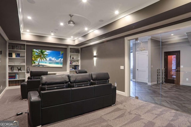 cinema with built in shelves, crown molding, baseboards, recessed lighting, and a raised ceiling