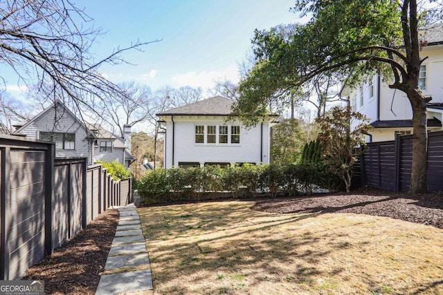 rear view of property featuring fence