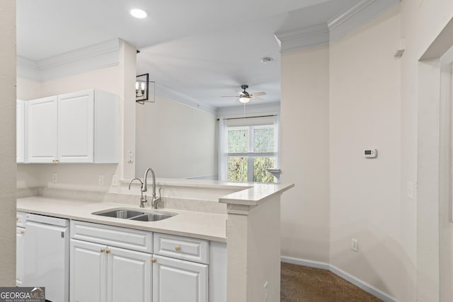 kitchen featuring white dishwasher, ornamental molding, a sink, light countertops, and white cabinets