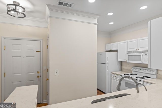 kitchen with visible vents, light stone counters, white cabinetry, white appliances, and crown molding