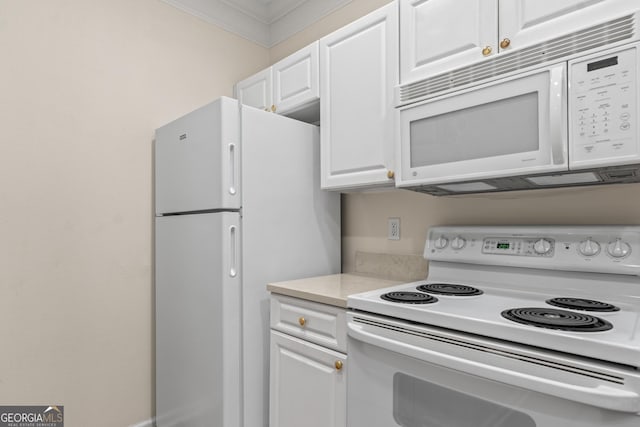 kitchen with white appliances, white cabinetry, and light countertops