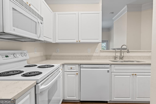 kitchen with crown molding, light countertops, white cabinets, white appliances, and a sink