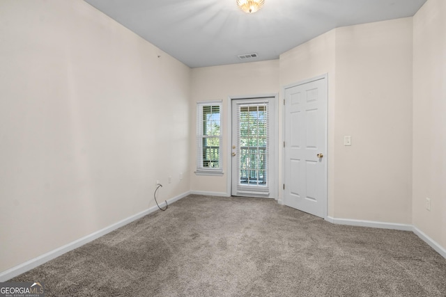 carpeted empty room with baseboards and visible vents