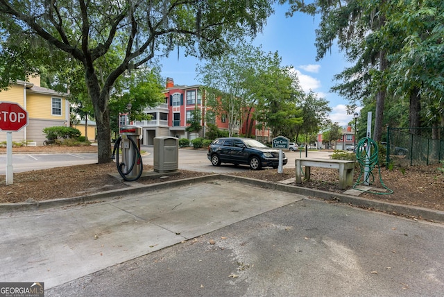 view of vehicle parking featuring fence